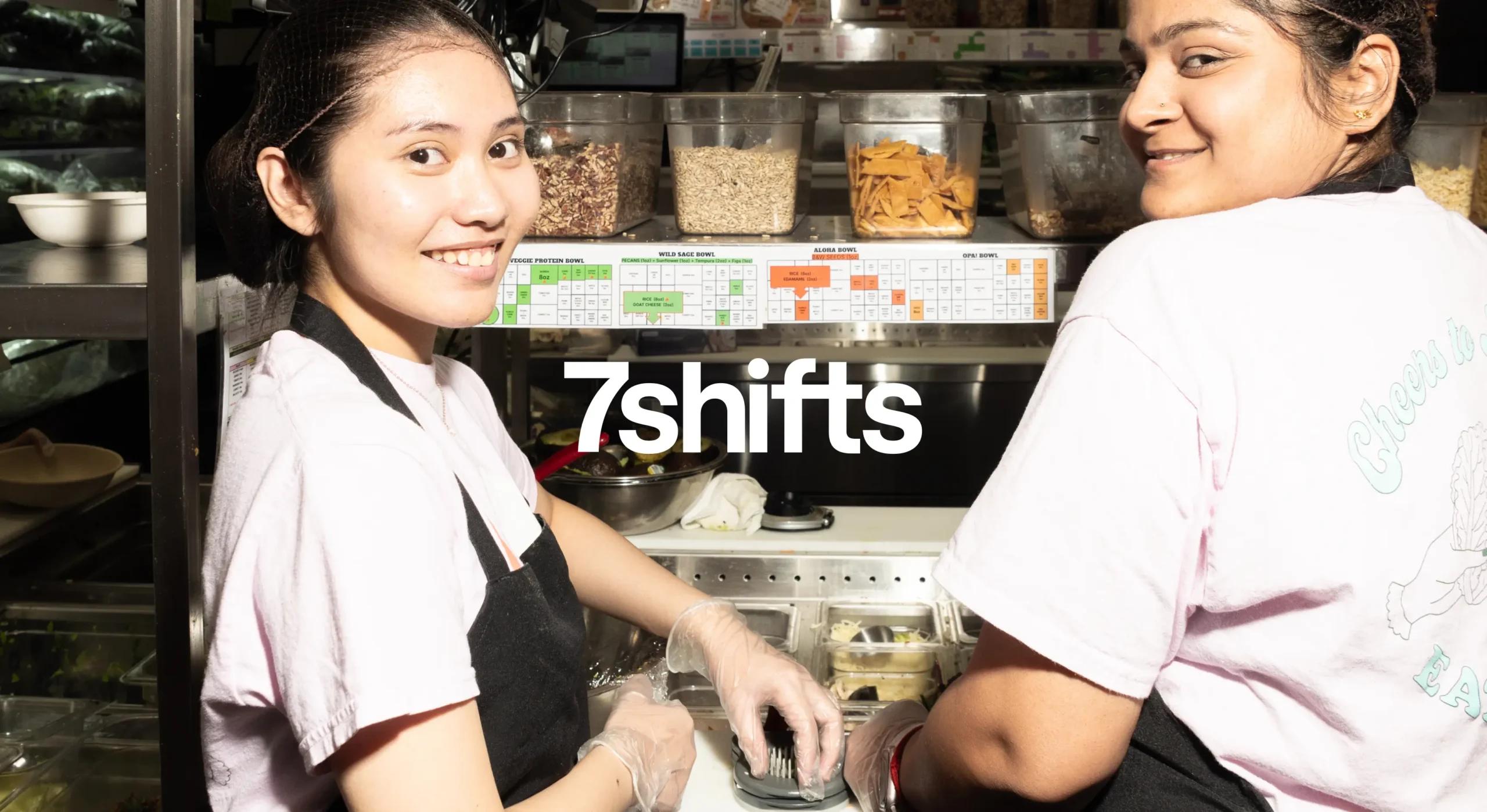 Women smiling in back of house while preparing salad takeout