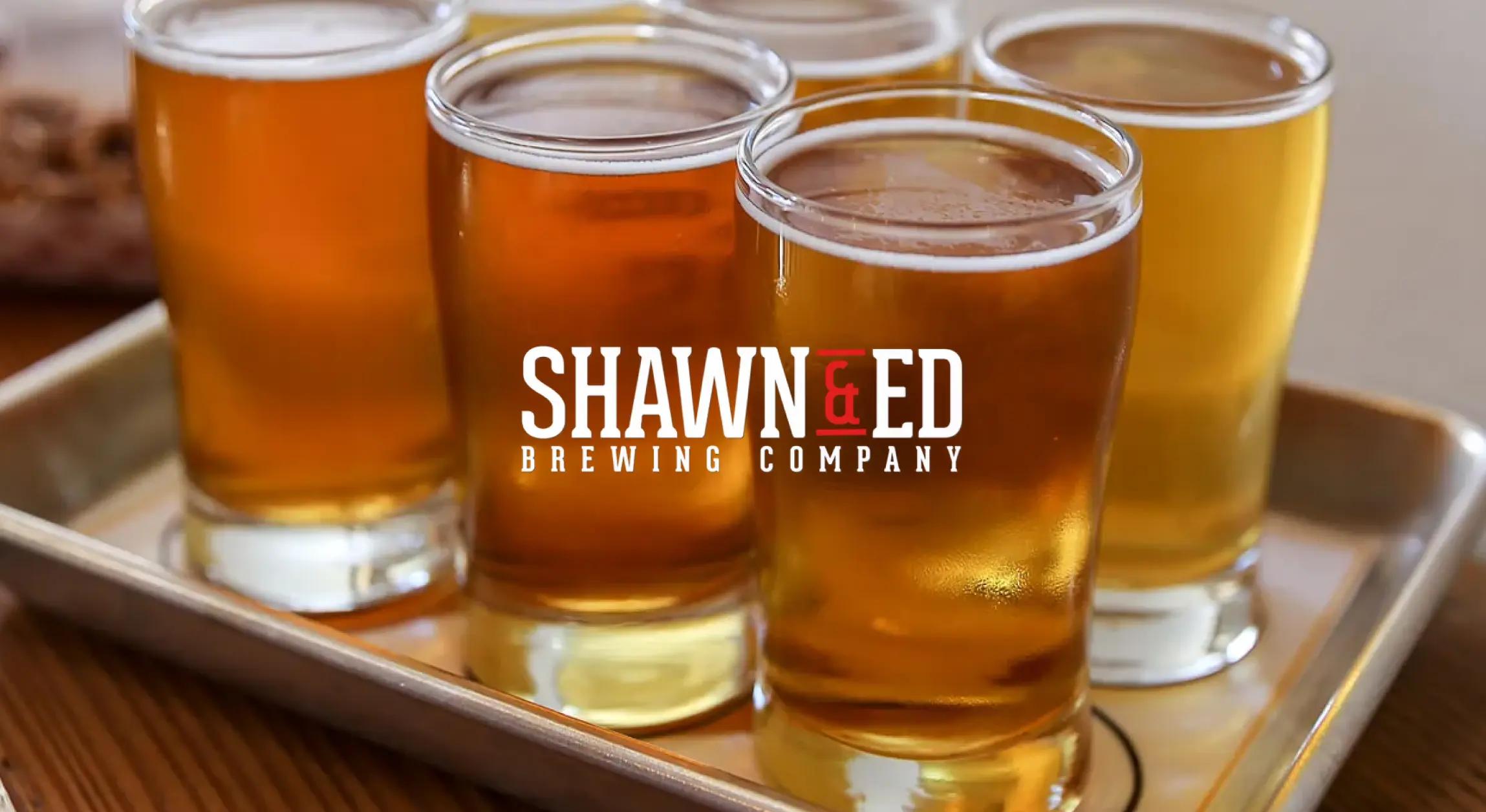 Shawn & Ed logo on top of photo of full beers