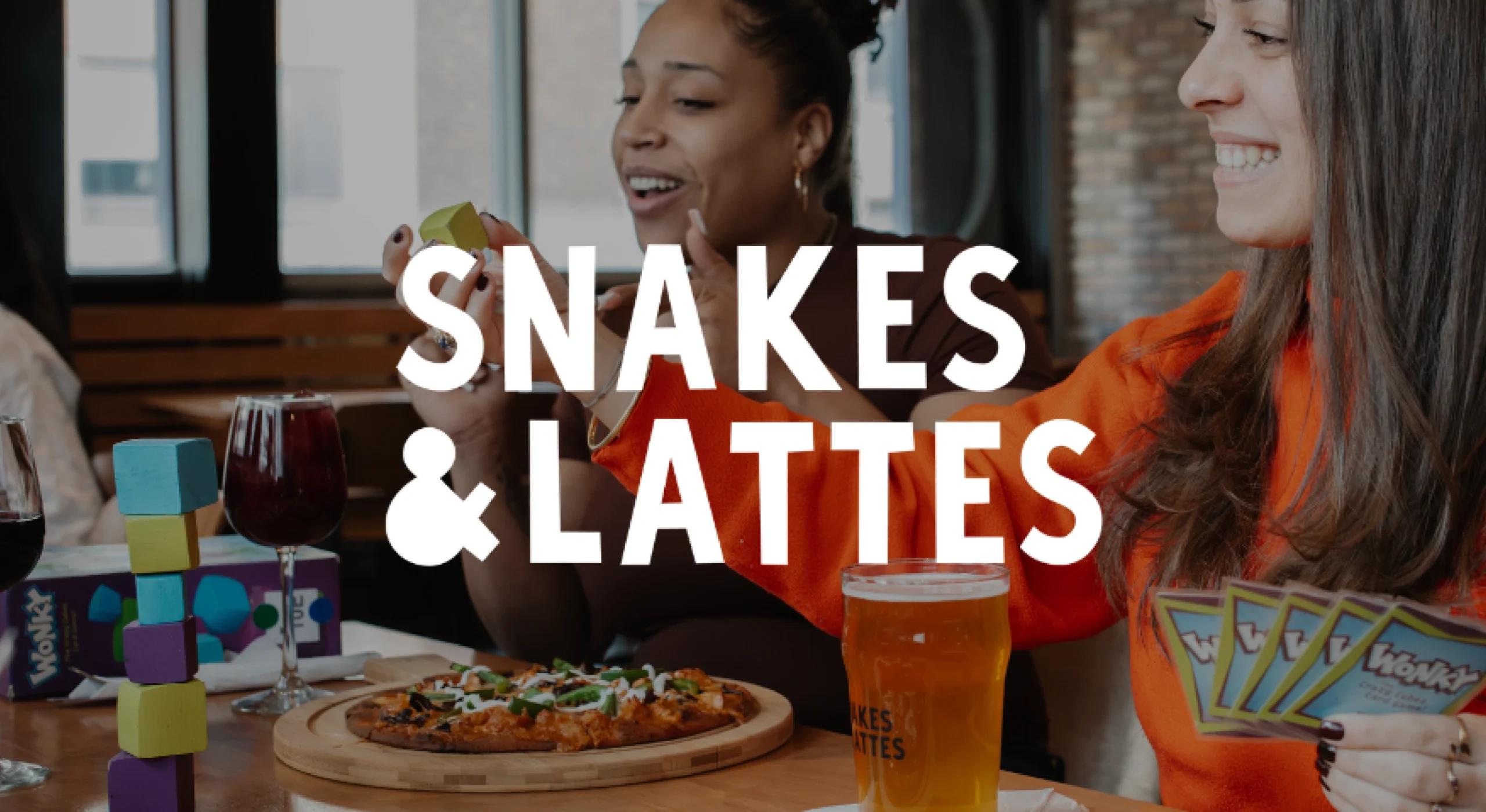 Photo of women eating at board game cafe Snakes & Lattes with logo on top