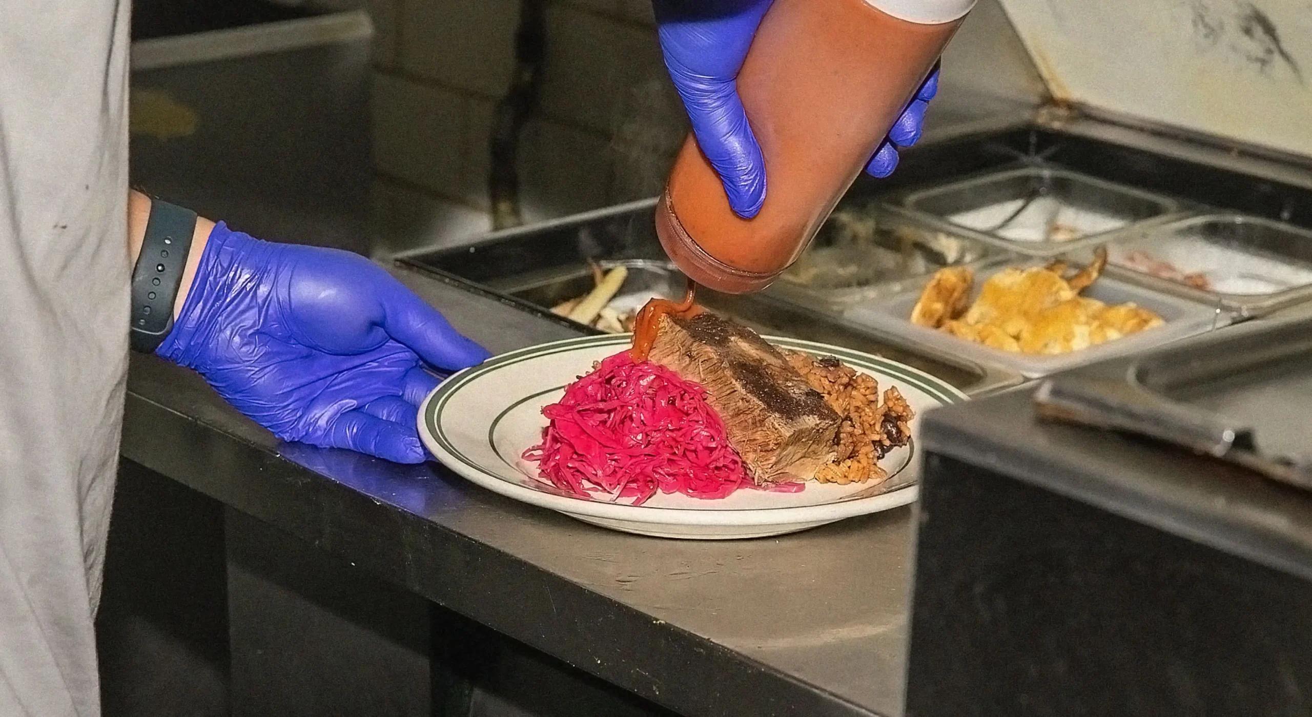 Back of house employee putting together a dish in the kitchen