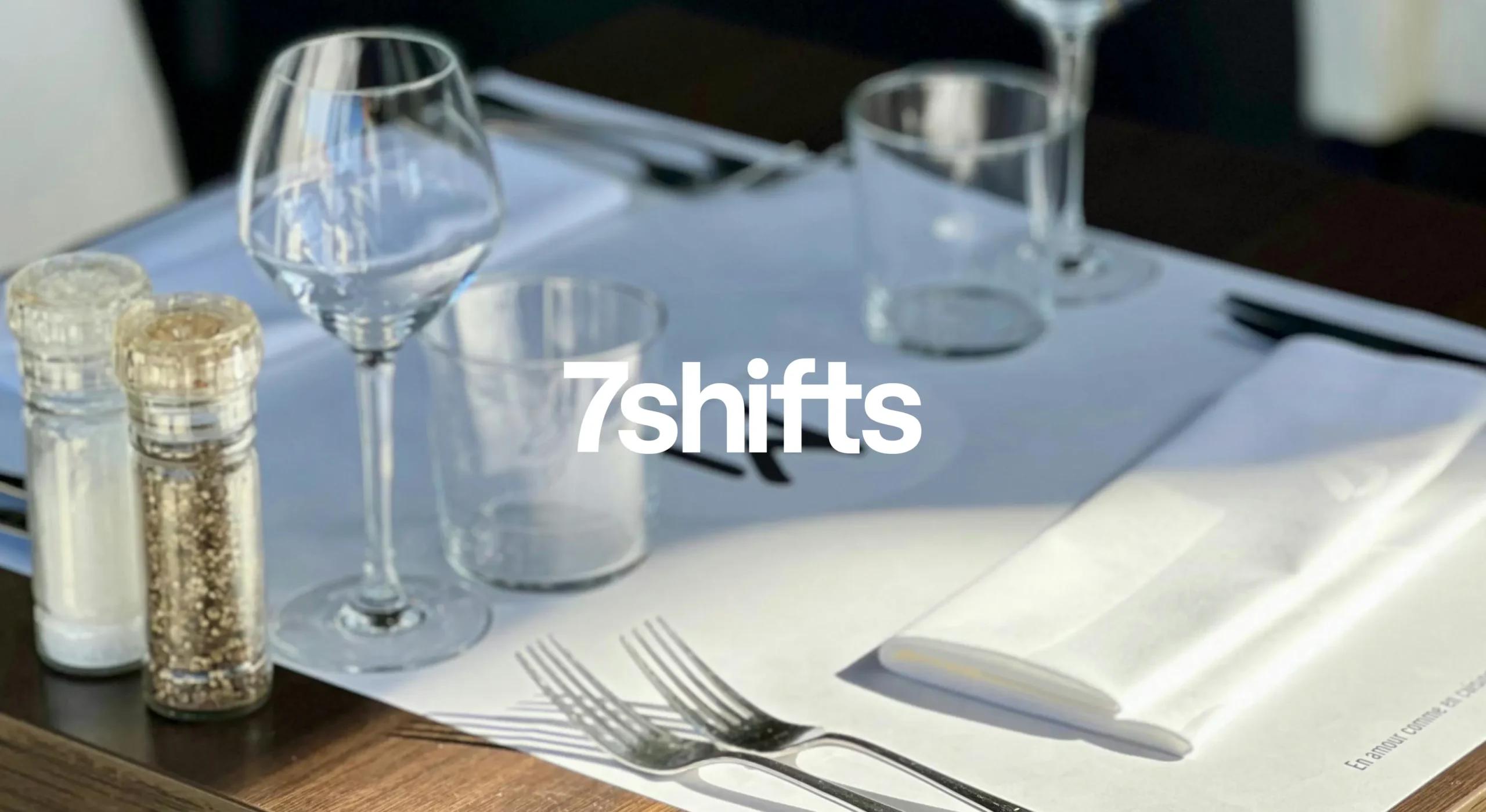 Image of a set restaurant table at sunset, 7shifts logo on top