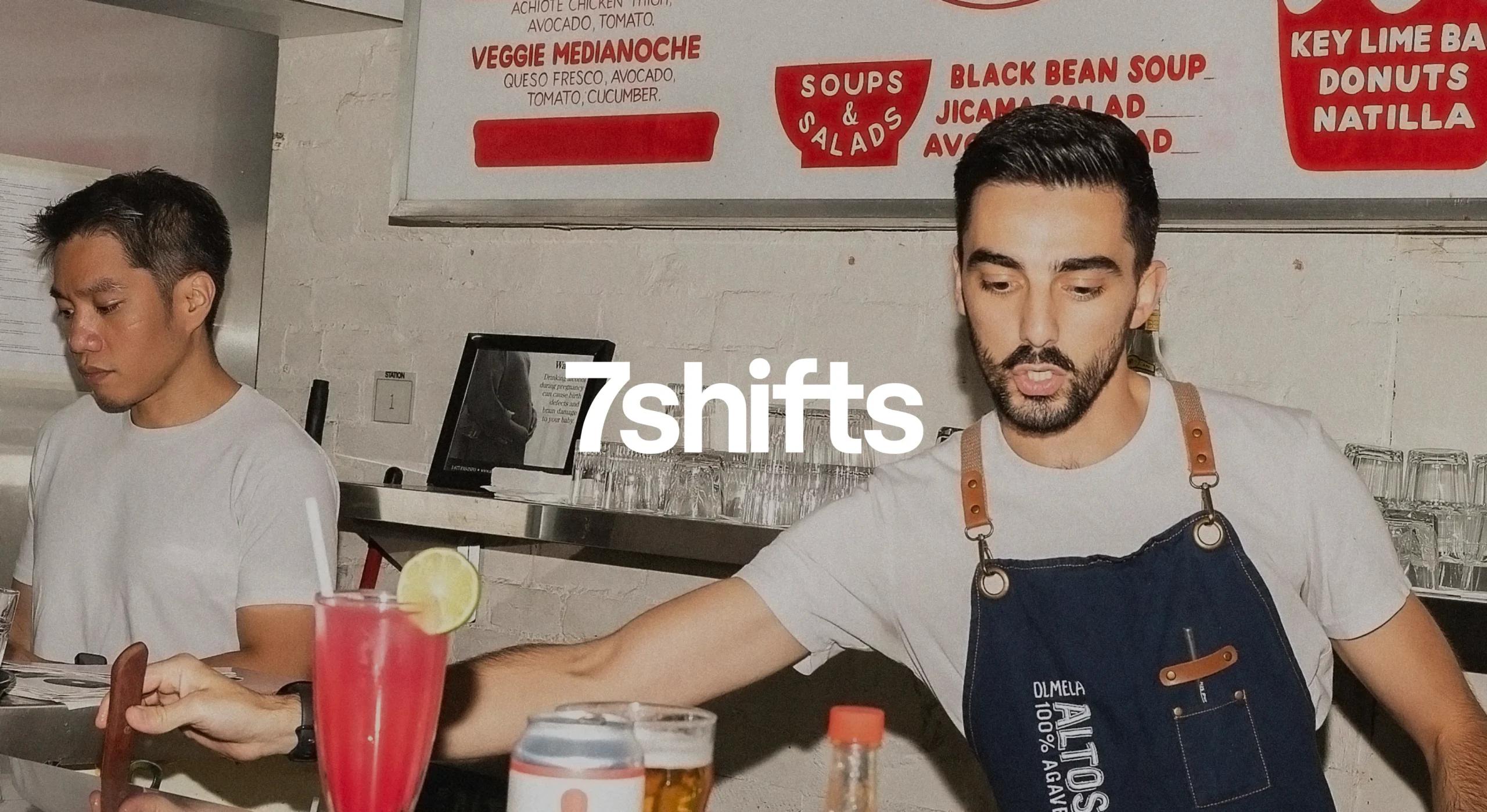 Bartender making cocktail behind restaurant counter