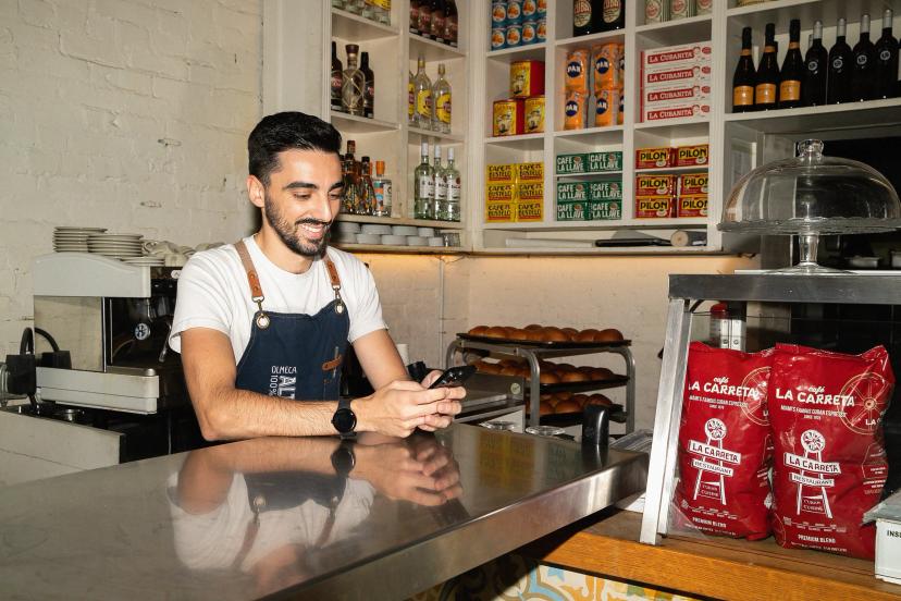 Restaurant worker on phone smiling