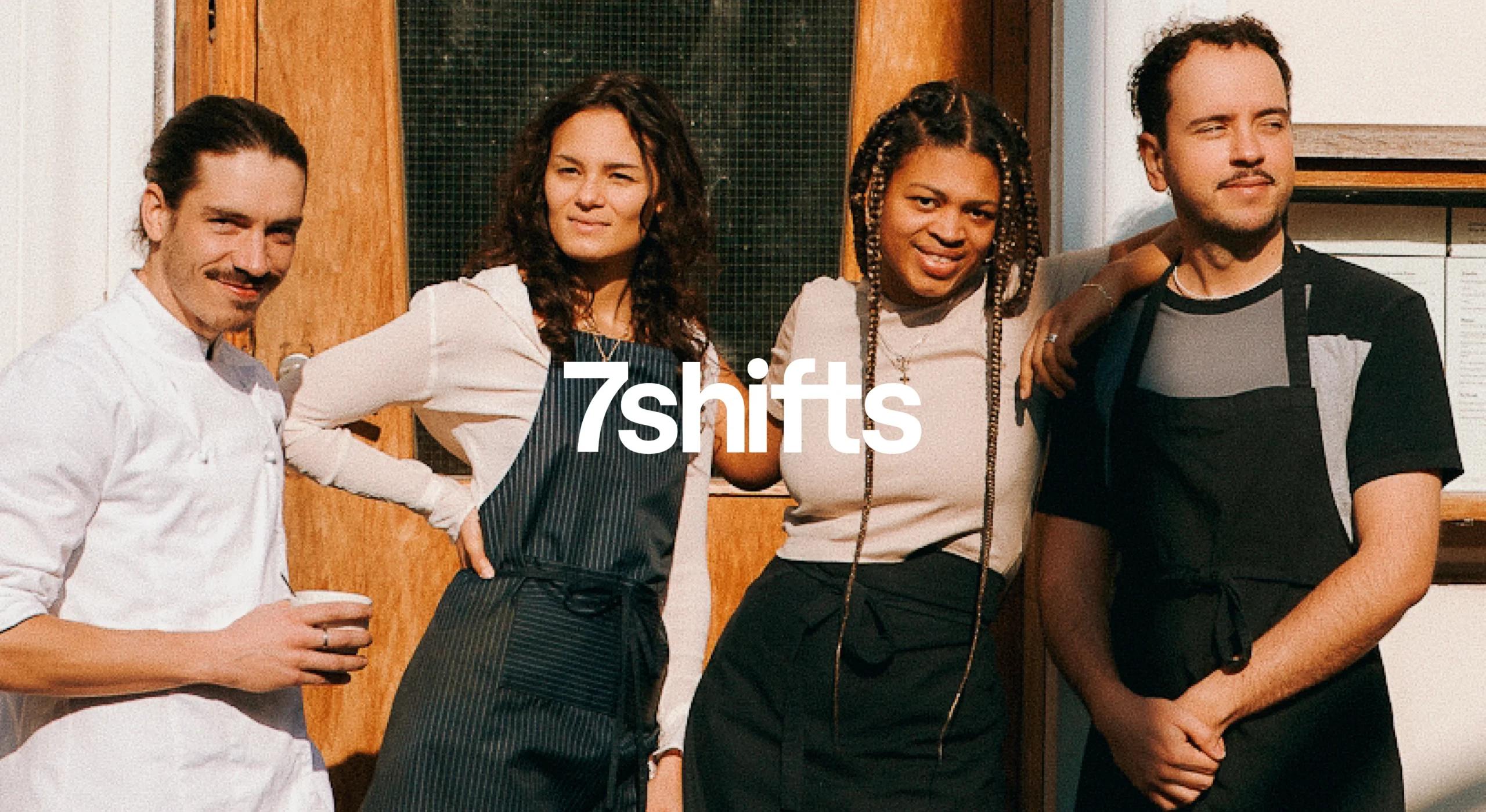 Four employees standing in front of restaurant.