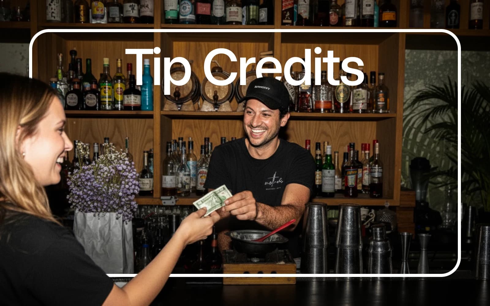 Bartender accepting cash from a customer across the bar