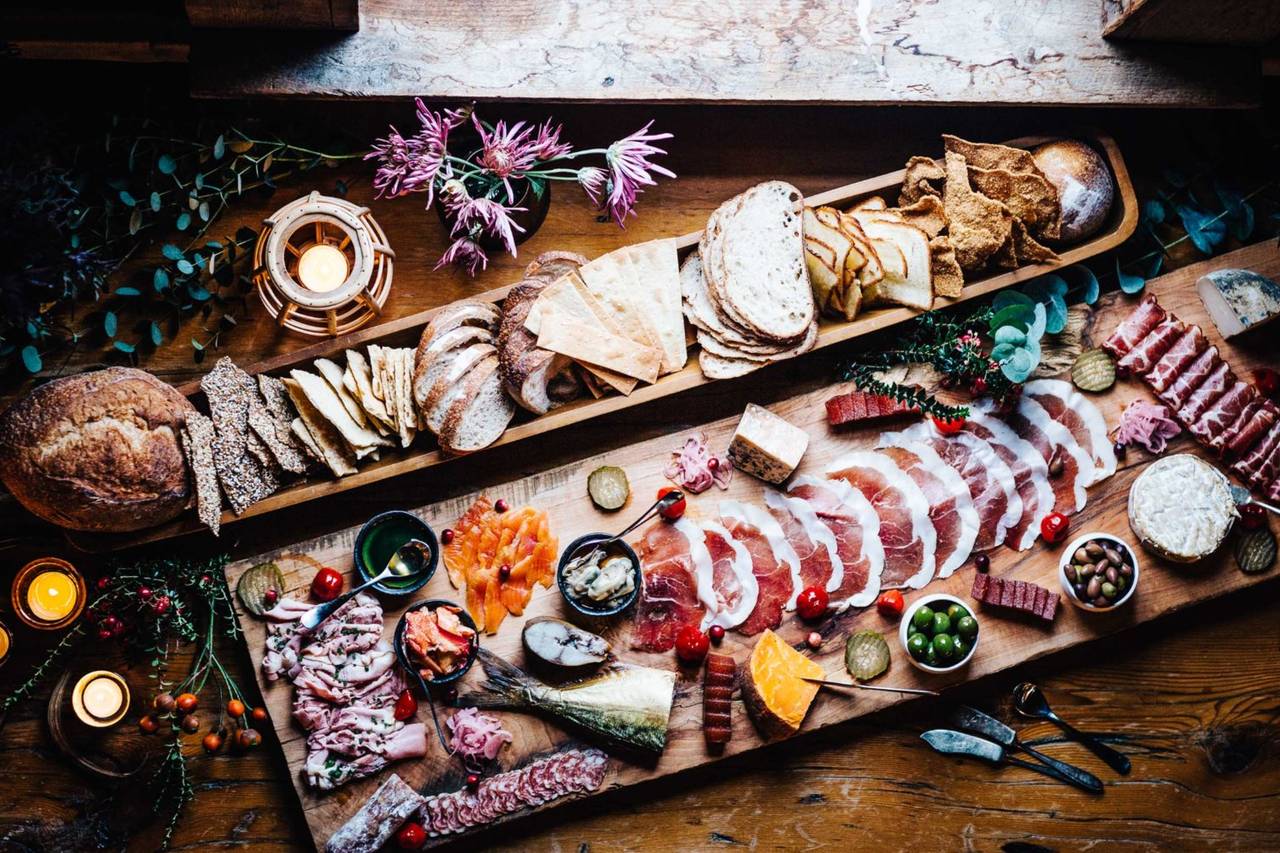 Gourmet charcuterie boards with breads, meats, and cheeses.