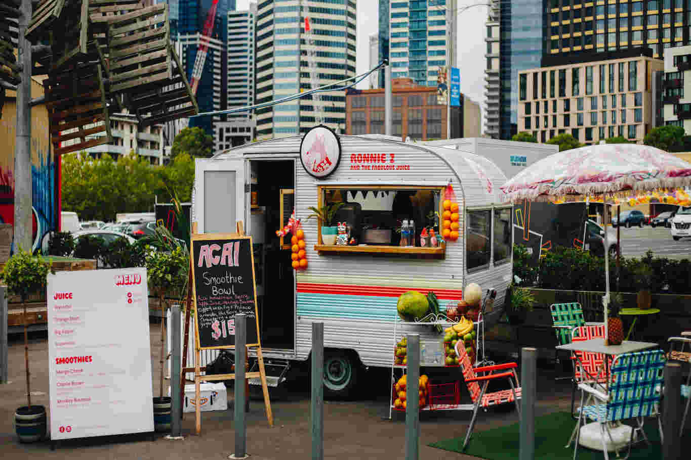 Colorful smoothie food truck in urban setting.