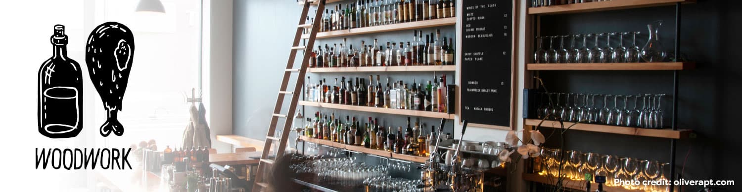 Woodwork bar with bottles and glassware display.