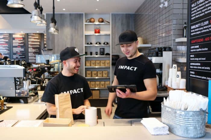 Two baristas working in a modern coffee shop.