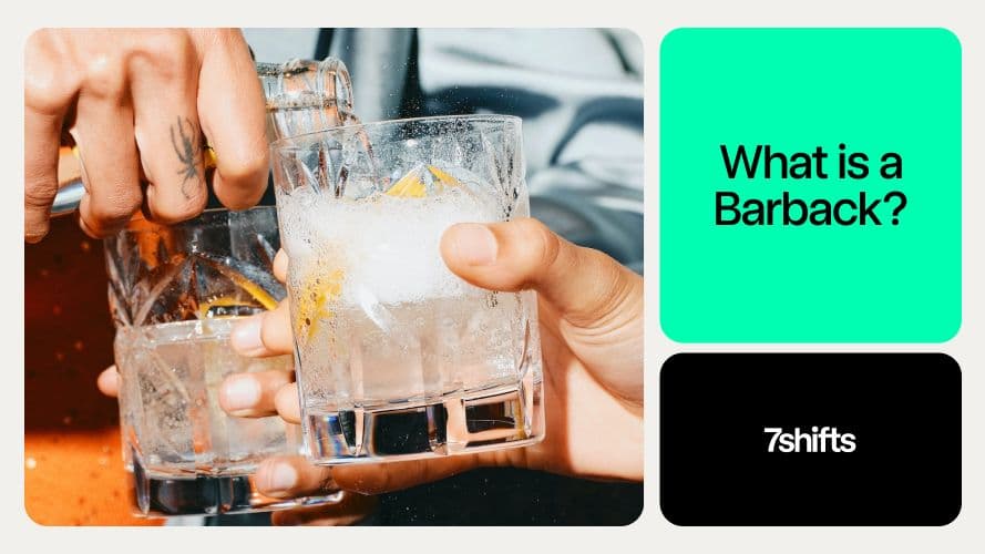 Hands holding cocktails with ice and lemon slice.