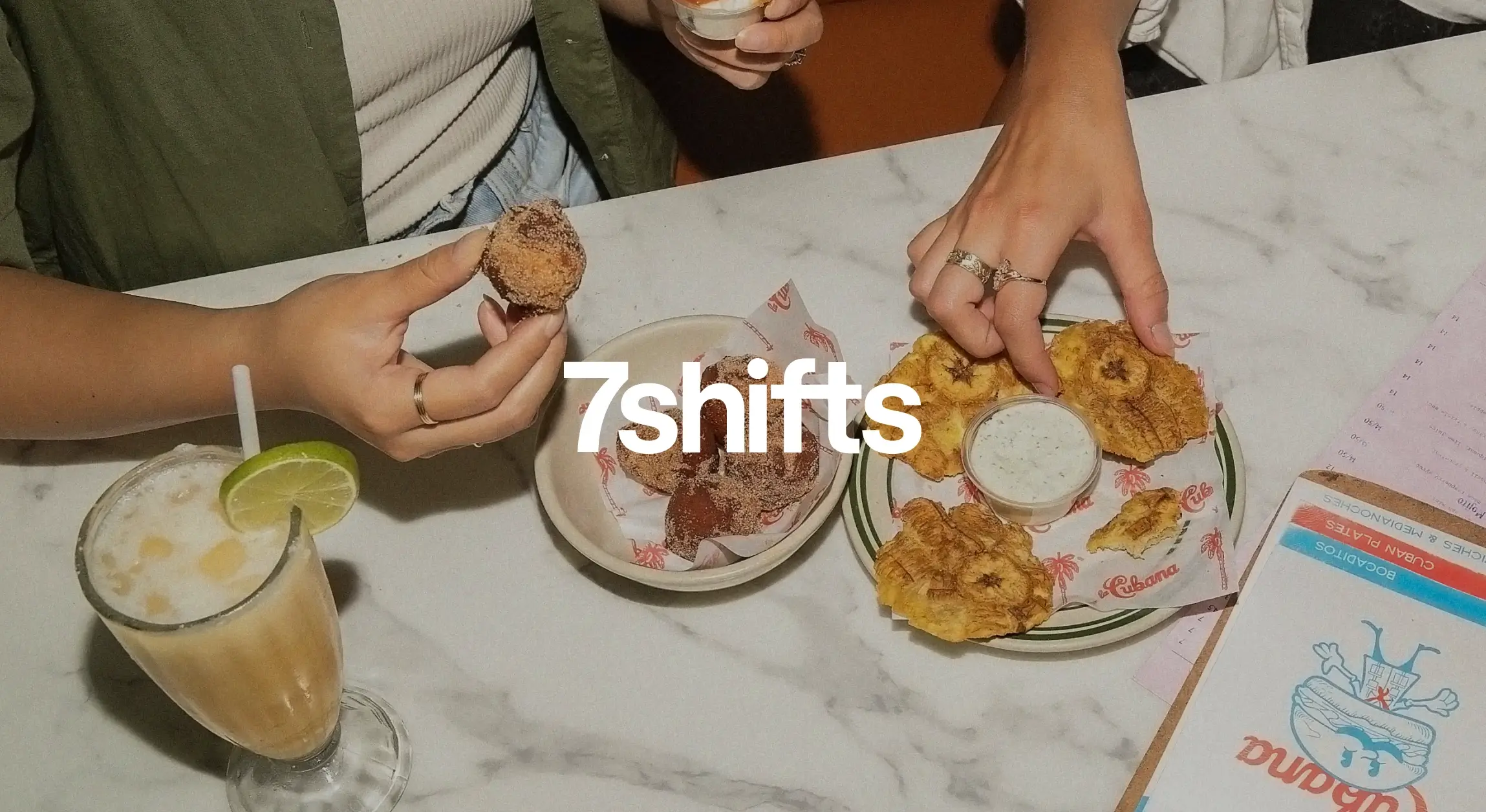 Enjoying drinks and snacks at a restaurant table.
