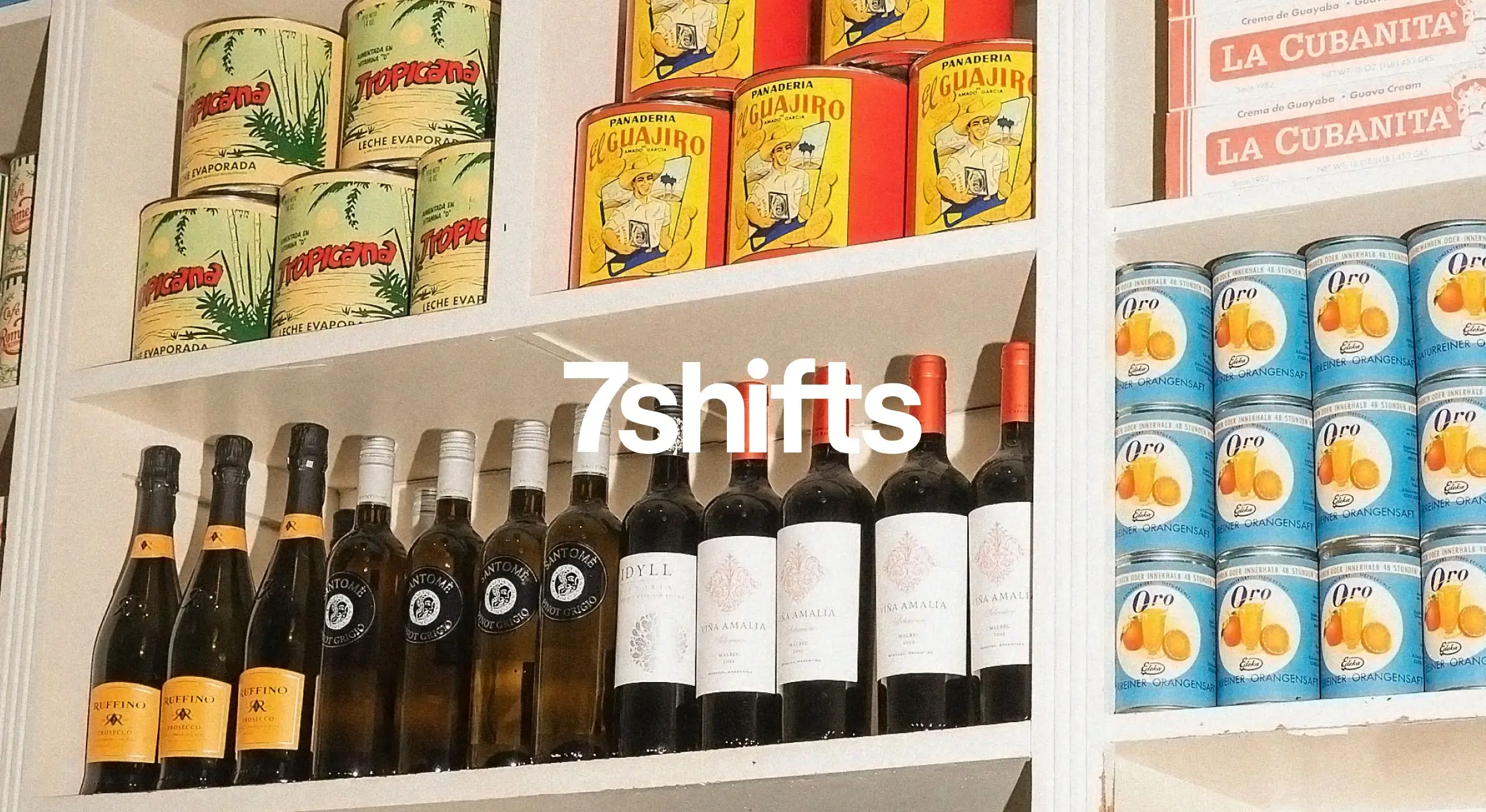 Cans and wine bottles on a grocery shelf